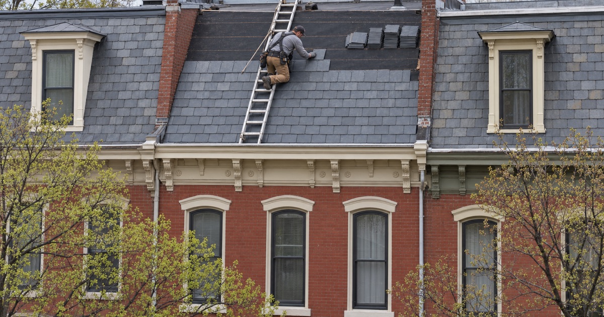 New slate being laid on the street-facing front slope of a prewar brick rowhouse in a Harrisburg historic district.